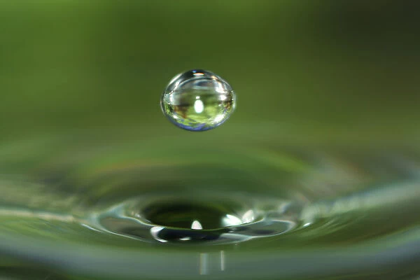 Macro water drop with green background
