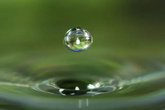 Framed Print : Macro water drop with green background