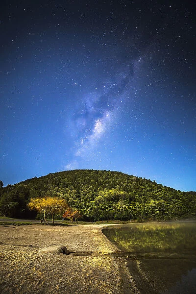 Milky Way over hill and lake