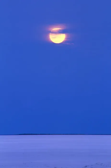 Framed Print : Moon rising over dry salt lake in desert