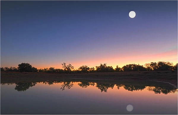 Moon rising over a lagoon at Comeroo, outback New South Wales, Australia
