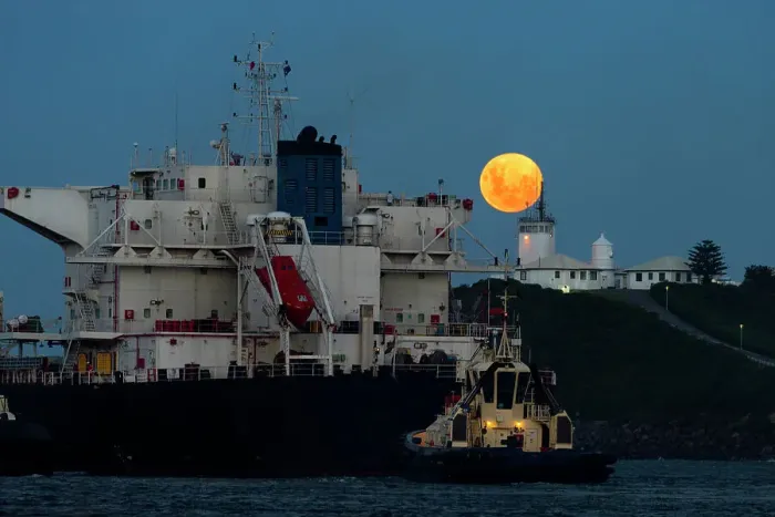 Framed Print : full moon rising above a lighthouse with ship in foreground
