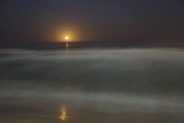 Moon rising over sea (defocussed)