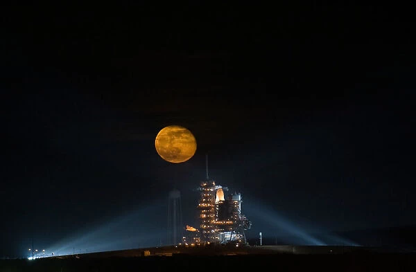 Moon rising behind the Space Shuttle Endeavour