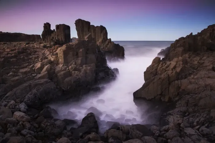 Framed Print : Motion blurred dreamy waves breaking on dramatic coastal basalt columns rock formations Framed Print : Motion blurred dreamy waves breaking on dramatic coastal basalt columns rock formations