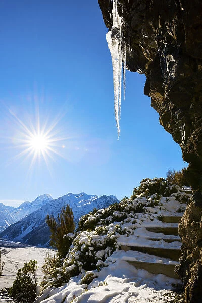 Mountain hike, trekking with icicle in snow