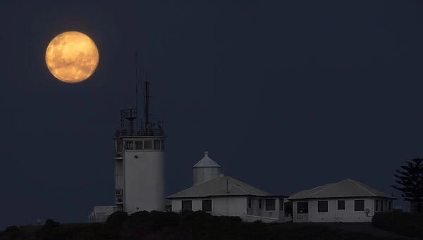 nobbys lighthouse with full moon in newcastle nsw