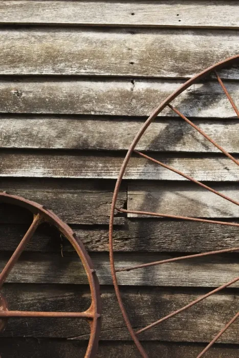 Framed Print : Old Wagon Wheels Against A Wooden Wall Framed Print : Old Wagon Wheels Against A Wooden Wall