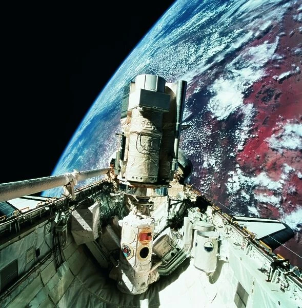 The open cargo bay of the space shuttle orbiting above earth