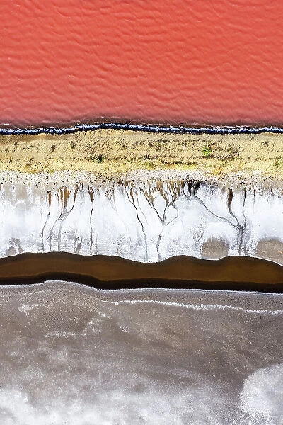 Overhead photo showing the shoreline of a vibrant coloured salt lake, Queensland, Australia