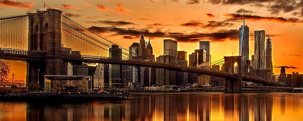 A panorama view of a fiery sunset over the Manhattan skyline