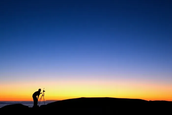 Framed Print : Photographer with camera and tripod