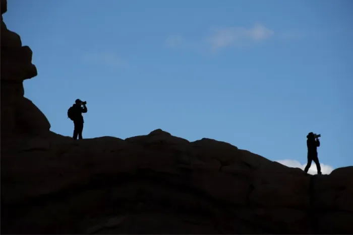 Framed Print : Photographers silhouretted against the sky in the Arches national park, Utah, USA