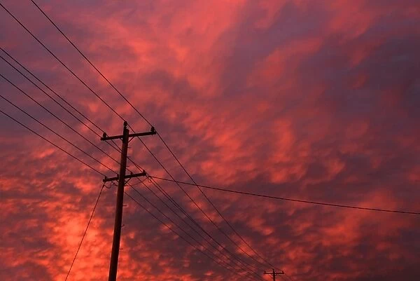 power pole and lines with clouds
