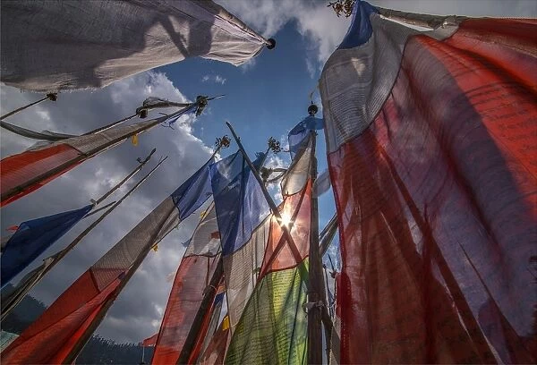 Prayer flags fluttering in the breeze on a mountain pass in central Bhutan