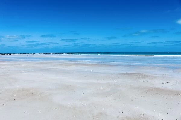 Pristine white sand of Cable Beach edged by the stunning turquoise water