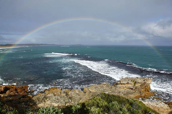 Rainbow over coast and ocean. Australia