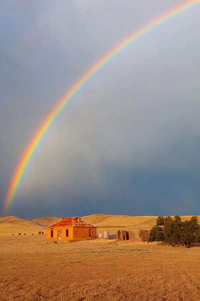 Rainbow over farmhouse
