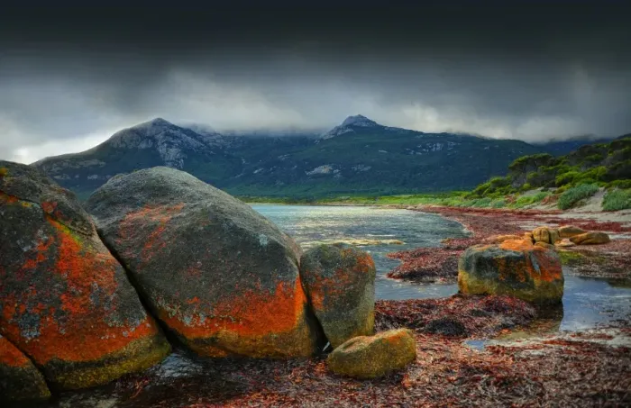 Framed Print : Red coloured boulders, caused by lichen growing at the high tide mark on Flinders Island, Bass Strait, Tasmania, Australia Framed Print : Red coloured boulders, caused by lichen growing at the high tide mark on Flinders Island, Bass Strait, Tasmania, Australia