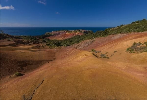 The rich red and ochre hues of the scarred landscape on Phillip island, situated just off Norfolk Island, south pacific ocean