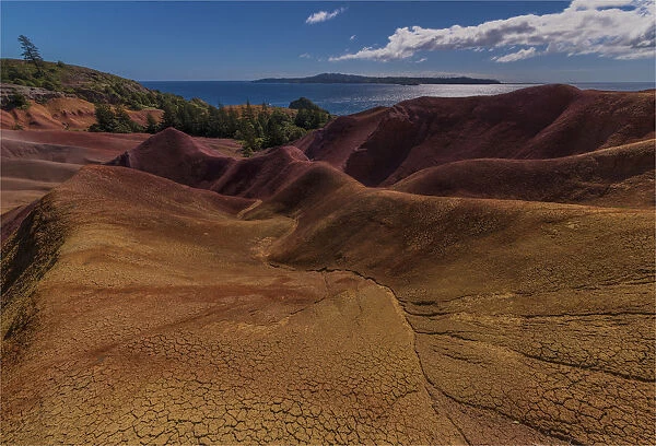 The rich red and ochre hues of the scarred landscape on Phillip island, situated just off Norfolk Island, south pacific ocean