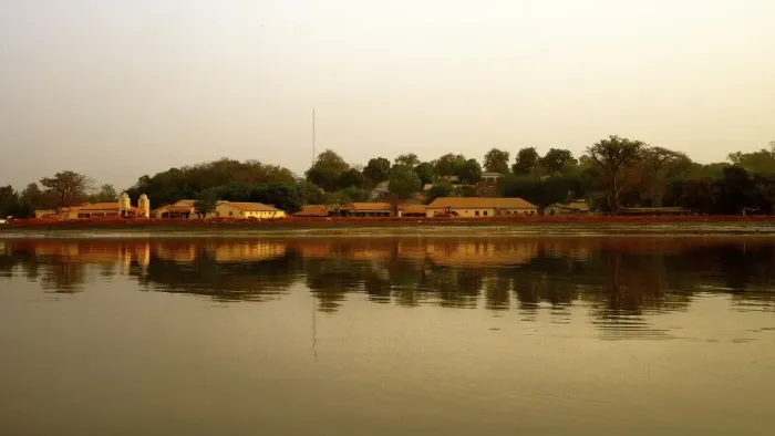 Framed Print : River Gambia at sunset with Tendaba settlement reflections on calm water during sunset