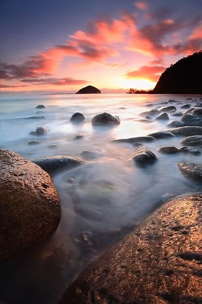 Rocks in ocean at sunrise