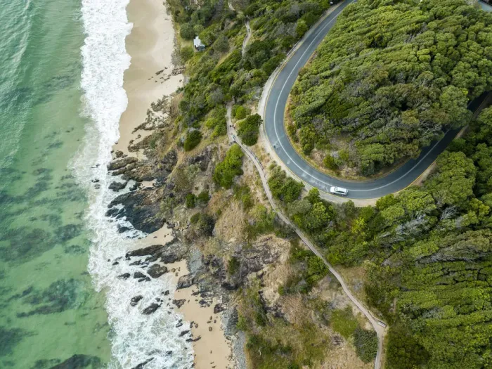 Framed Print : rocky outcrop into ocean with road Framed Print : rocky outcrop into ocean with road