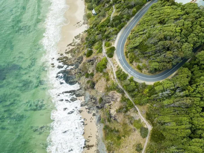 Framed Print : rocky outcrop into ocean with road