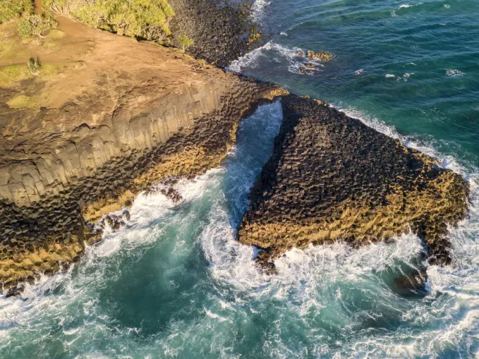 Framed Print : rocky outcrop into ocean at sunrise