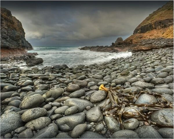 The rocky shoreline and approaching storm near Cape Schanck at first light, Mornington Peninsular, southern Victoria