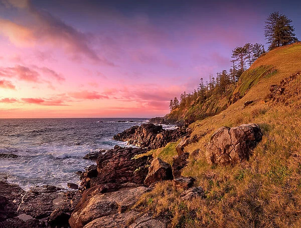 Rugged cliffs and sunrise light near Two Chimneys reserve, Norfolk Island, Australia, Southern South Pacific