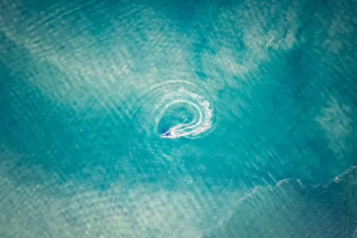 Framed Print : A sailing boat is driving a cycle in the middle of the ocean