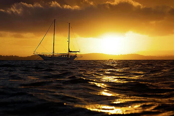 sailing boat on lake at sunset