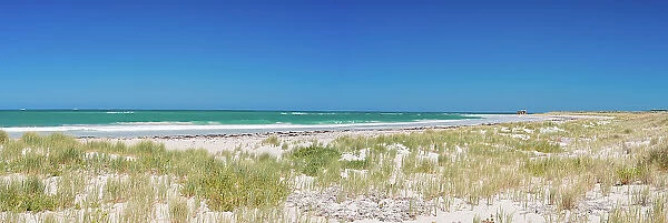 Sandy beach dune and blue skies
