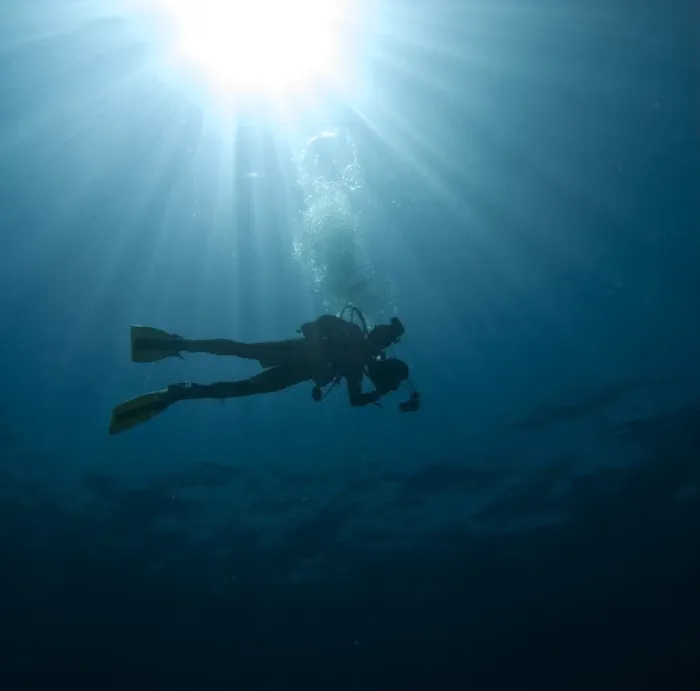 Framed Print : Scuba diver with sun burst