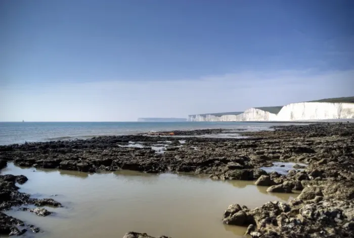 Framed Print : Seven Sisters white cliffs rocky beach at low tide