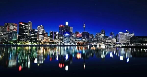 Skyline. View of Sydney skyline reflecting in water at night, Australia