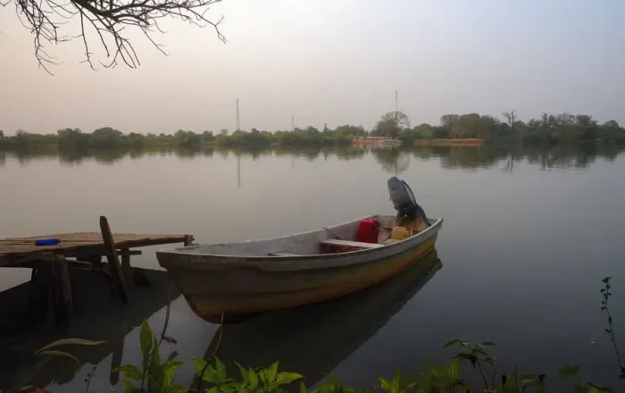 Framed Print : Small Fishing boat on banks of river Gambia in early morning before sunrise Framed Print : Small Fishing boat on banks of river Gambia in early morning before sunrise