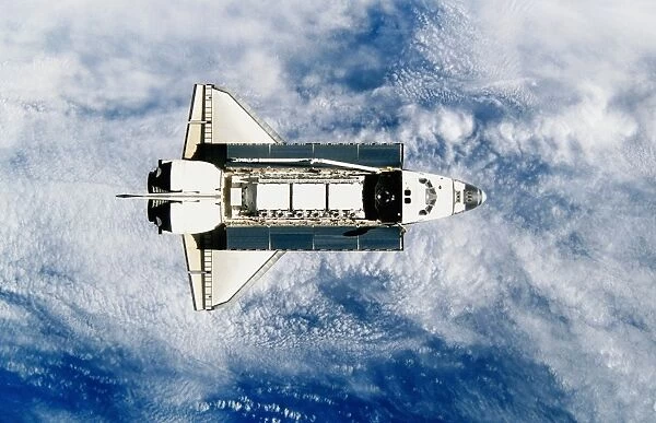 Space shuttle orbiting earth, satellite view