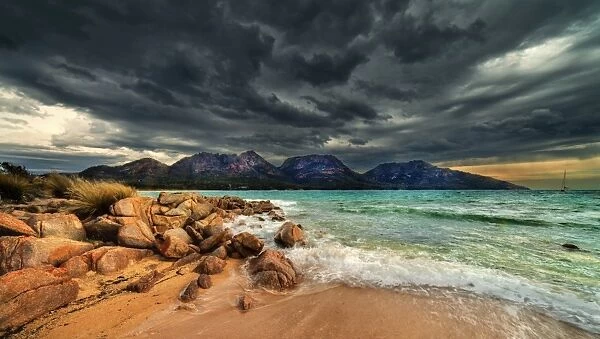 Storm clouds over mountains and beach