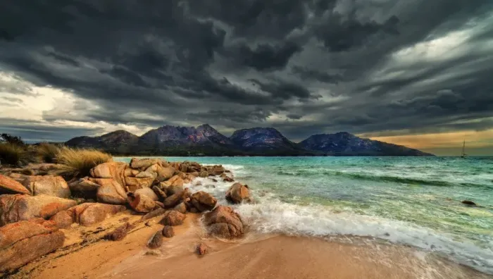 Framed Print : Storm clouds over mountains and beach
