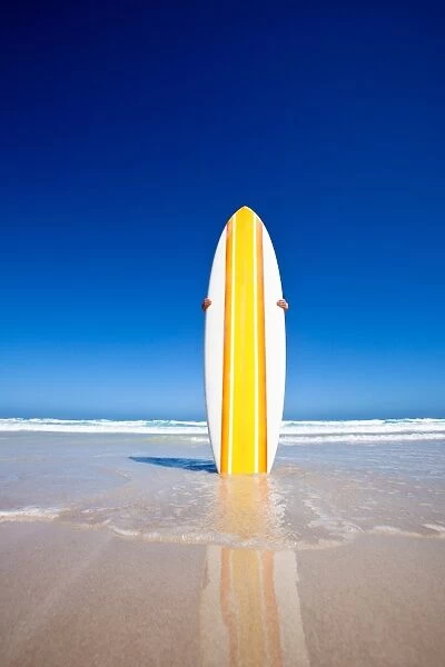 Striped retro surf board on a beach. Australia