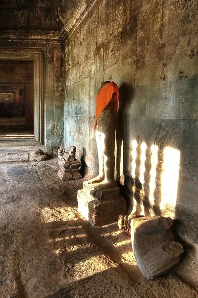 Sunlight Shining Onto The Headless Statue in Angkor Wat, Siem Reap, Cambodia