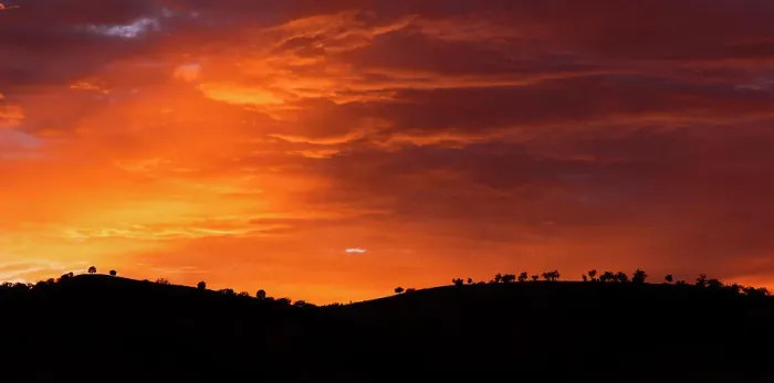Framed Print : sunrise colours in the clouds with silhouette of mountain