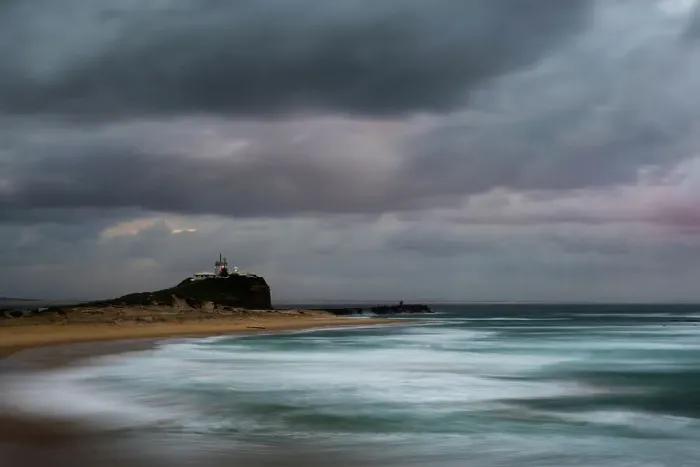 Framed Print : sunrise and a stormy mood at lighthouse and beach Framed Print : sunrise and a stormy mood at lighthouse and beach