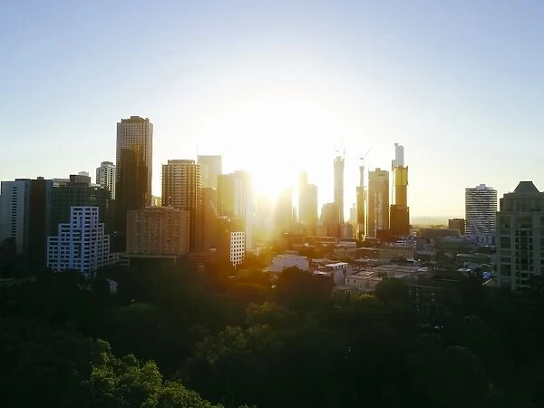 Sunset Aerial view of the Melbourne skyline with trees and Carlton Gardens