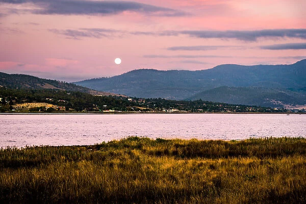 Sunset and moon rise over River Derwent. Huon valley, Hobart suburbs, Tasmania