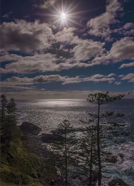 Sunstar and clouds along the Norfolk Island coastline