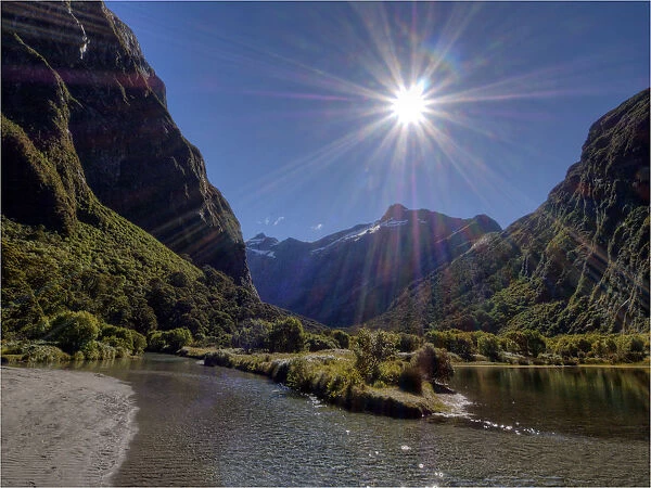 Sunstar shining on the Clinton river, South Island, New Zealand